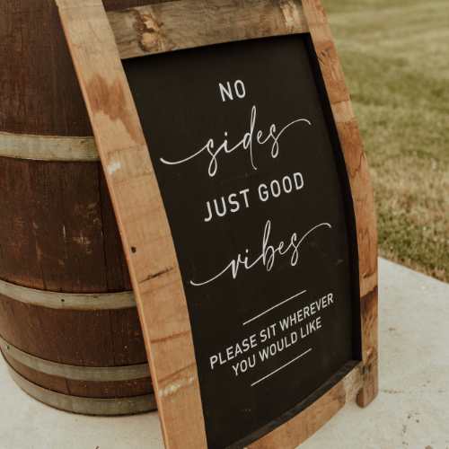 wedding ceremony sign against a wine barrel