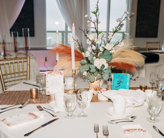 a boho themed wedding reception guest table setup with personalized details